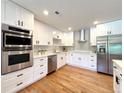 Updated kitchen features stainless appliances, quartz countertops, and sleek cabinetry at 9451 E Evans Pl, Denver, CO 80231