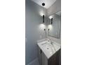 Modern bathroom features a vanity with quartz countertop and pendant lighting at 2330 Eliot St # 1, Denver, CO 80211