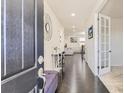 Elegant foyer with dark hardwood floors, a decorative mirror and a view into the living spaces at 10863 Endeavor Dr, Parker, CO 80134