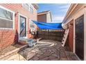 Home's rear patio with stone pavers, garden and back door access at 2983 Fulton St, Denver, CO 80238