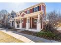 Inviting two-story home with a covered front porch and classic architectural details at 2983 Fulton St, Denver, CO 80238