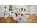 Airy living room featuring a neutral color palette and hardwood flooring at 2983 Fulton St, Denver, CO 80238