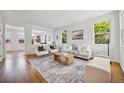 Bright and open living room with hardwood floors, large windows, and neutral decor at 2983 Fulton St, Denver, CO 80238