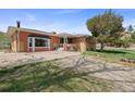 Ranch style home with combination brick and siding, a bay window, and mature landscaping at 12101 Riverdale Rd, Brighton, CO 80602