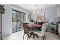 Cozy dining area with sliding door and outdoor view, chandelier, and seating for four at 60 S Moline St, Aurora, CO 80012