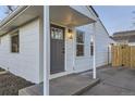 Newly remodeled front entrance with gray door and covered porch at 1840 S Shoshone St, Denver, CO 80223