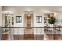 Welcoming entryway with beautiful hardwood floors and views to the formal dining and living areas at 6303 Ellingwood Point Pl, Castle Rock, CO 80108