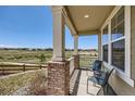 Relaxing front porch with views of open space, ideal for outdoor seating at 14521 Vancouver Pl, Parker, CO 80134