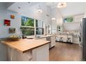 Bright kitchen featuring an island with butcher block counter, stainless appliances, and lots of natural light at 6621 E Peakview Pl, Centennial, CO 80111