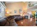 Spacious living room featuring a cozy fireplace, hardwood floors, and ample natural light at 11207 Day Star Ct, Parker, CO 80138