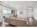 Inviting living area with hardwood floors, modern furniture, and a sliding glass door to the patio at 5142 N Quemoy Ct, Aurora, CO 80019