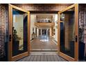 Grand foyer featuring a compass inlay, brick accent walls and an upper-level view at 375 S University Blvd, Denver, CO 80209