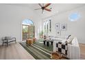 Bright living room featuring vaulted ceilings, large windows, and a cozy seating area at 375 S University Blvd, Denver, CO 80209