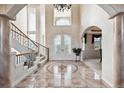 Grand foyer featuring a decorative tiled floor, soaring ceilings, and a wrought iron staircase at 1185 W 140Th Dr, Westminster, CO 80023