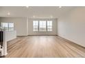 Bright and spacious living room featuring hardwood floors, large windows, and neutral color palette at 11039 Snowdon St, Parker, CO 80134