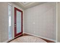 Beautiful entryway with a decorative front door, stylish wallpaper, and hardwood floors offers a welcoming entrance at 16043 Azalea Ave, Parker, CO 80134