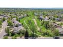 An aerial view of a home and neighborhood with lush green space and walking paths at 20591 E Weaver Ave, Aurora, CO 80016