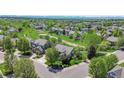 Scenic aerial view of a home in a neighborhood adjacent to a park with mature trees at 20591 E Weaver Ave, Aurora, CO 80016