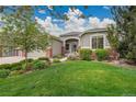 Charming home with a well-manicured lawn, lush landscaping, and beautiful curb appeal at 20591 E Weaver Ave, Aurora, CO 80016