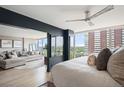 Bedroom with an open wall to the living area and expansive views from the large windows at 3100 E Cherry Creek South Dr # 1403, Denver, CO 80209