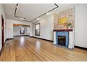 Bright living room featuring wood floors, a fireplace, and an open layout at 308 Inca St, Denver, CO 80223