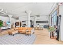 Open-concept living space boasting hardwood floors, exposed beams, and city views through large windows at 2000 Arapahoe St # 503, Denver, CO 80205