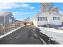 Ranch style home with a snow covered yard and driveway at 537 S 2Nd Ave, Brighton, CO 80601