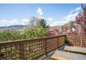 Outdoor deck with wood railings offering scenic views of trees and mountains at 600 Cascade Dr, Golden, CO 80403