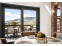Bright dining area with a round table, deck access, and a scenic mountain view at 600 Cascade Dr, Golden, CO 80403
