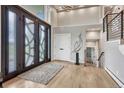 Entryway featuring high ceilings, modern lighting, and a decorative sculpture that enhances the home's appeal at 1820 S State 83 Hwy, Franktown, CO 80116