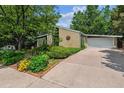 Well maintained single-story home with a spacious driveway and landscaped front yard at 9113 E Evans Way, Denver, CO 80231