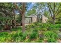 Two-story brick home with large windows and lush landscaping at 9113 E Evans Way, Denver, CO 80231