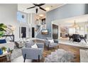 Bright, open-concept living area featuring a stylish staircase, a vaulted ceiling, and seamless flow to the dining area at 13071 Emerson St, Thornton, CO 80241