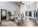 Spacious living room with soaring ceilings, modern furnishings, and a grand entrance at 13071 Emerson St, Thornton, CO 80241