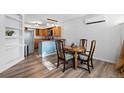 Cozy dining room features wood flooring, modern light fixtures, and seamless flow into the adjacent kitchen at 7550 Stuart St, Westminster, CO 80030