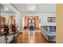 Bright living room featuring hardwood floors, archway to dining room, and neutral décor at 2630 Albion St, Denver, CO 80207