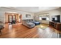 Comfortable living room with hardwood floors, a large sectional sofa, and natural light at 2630 Albion St, Denver, CO 80207