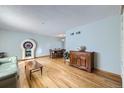 Bright living room with hardwood floors and dining area at 547 S Flower St, Lakewood, CO 80226