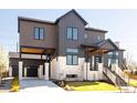 Modern two-story home boasts a unique design with mixed materials and eye-catching curb appeal at 8230 W Tennessee Ct, Lakewood, CO 80226