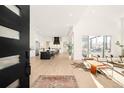 Bright foyer featuring an open floor plan, hardwood floors, and seamless transition to the kitchen and living areas at 8230 W Tennessee Ct, Lakewood, CO 80226