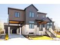Beautiful modern exterior featuring a black garage door, concrete driveway, and sleek design at 8230 W Tennessee Ct, Lakewood, CO 80226