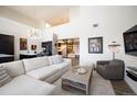 A spacious living room features a modern staircase, high ceilings, and an open-concept design at 5677 S Park Pl # B310, Englewood, CO 80111