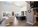 Bright living room with island kitchen, tall windows and spiral staircase to upper level at 5677 S Park Pl # B310, Englewood, CO 80111