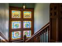 Close-up of a stained glass window featuring intricate patterns and a vibrant color palette along a staircase at 1435 Vine St # 5, Denver, CO 80206