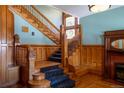 Grand wooden staircase with ornate carvings and a stained glass window, creating a vintage ambiance at 1435 Vine St # 5, Denver, CO 80206