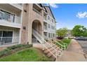 Exterior of a three-story condo showing walkways leading to unit front doors and balconies at 15700 E Jamison Dr # 3-307, Englewood, CO 80112