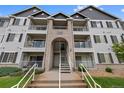 Exterior of a well maintained, three-story condo building showing walkways leading to unit front doors and balconies at 15700 E Jamison Dr # 3-307, Englewood, CO 80112