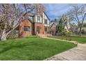 Landscaped front yard with walkway leading to Tudor-style home at 1650 Locust St, Denver, CO 80220