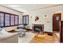 Cozy living room with hardwood floors, fireplace, and ample natural light at 1650 Locust St, Denver, CO 80220