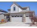 Spacious three-car garage with carriage doors and stone detailing at 434 N Old Hammer St, Aurora, CO 80018